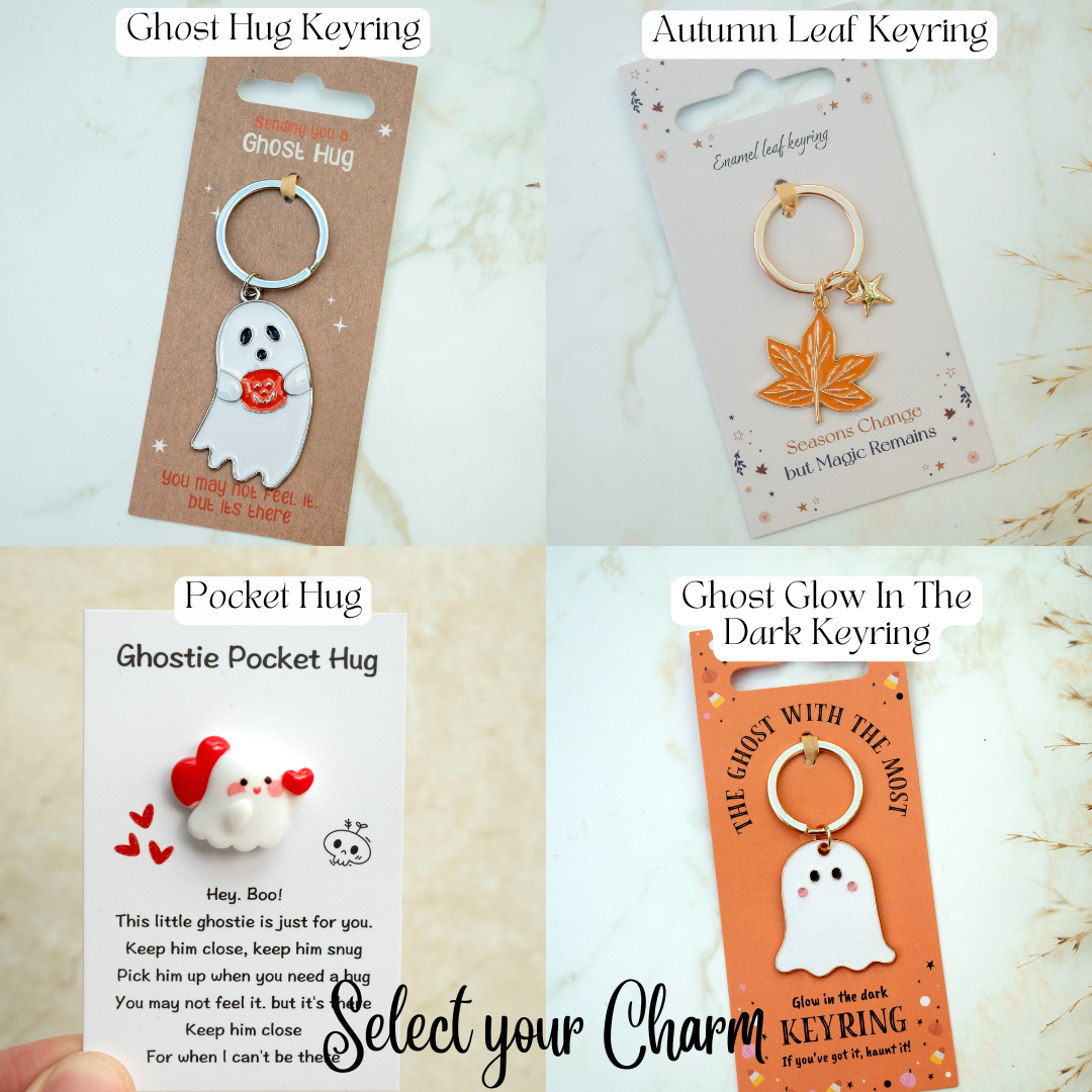 Collection of ghost-themed keyrings with packaging on a light background