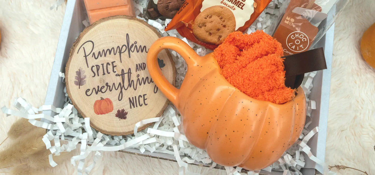 Pumpkin-themed gift set with a pumpkin-shaped container and wooden sign on a white background.