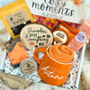 Gift box with pumpkin spice-themed items including a mug, soap, and tea.