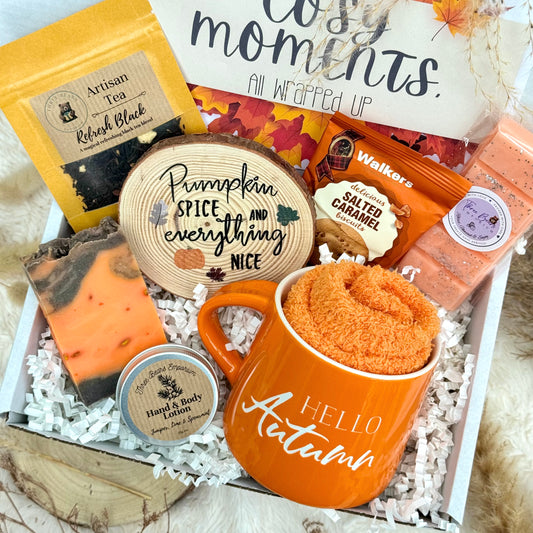 Gift box with pumpkin spice-themed items including a mug, soap, and tea.