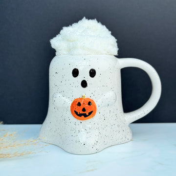 Ghost Halloween Mug, holding an orange pumpkin with white fluffy cosy socks