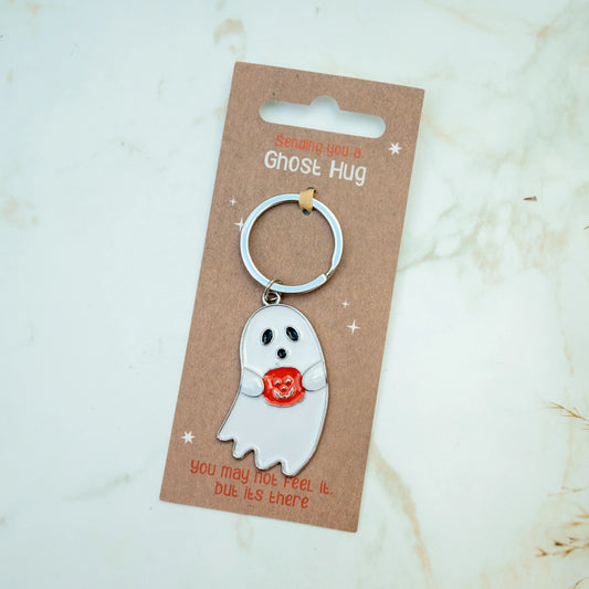 a ghost keyring on a card with the phrase sending a ghost hug keyring, you may not feel it but its there. 