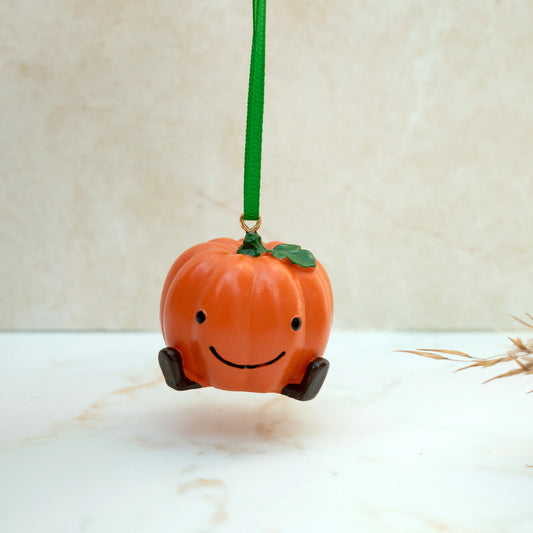 Orange Pumpkin with a smiling face, with green thread for hanging.