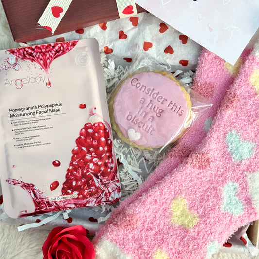 Heart themed items including a facial mask, cookie, and heart-patterned socks.
Socks & Treats Just For You | Mini Letterbox Gift